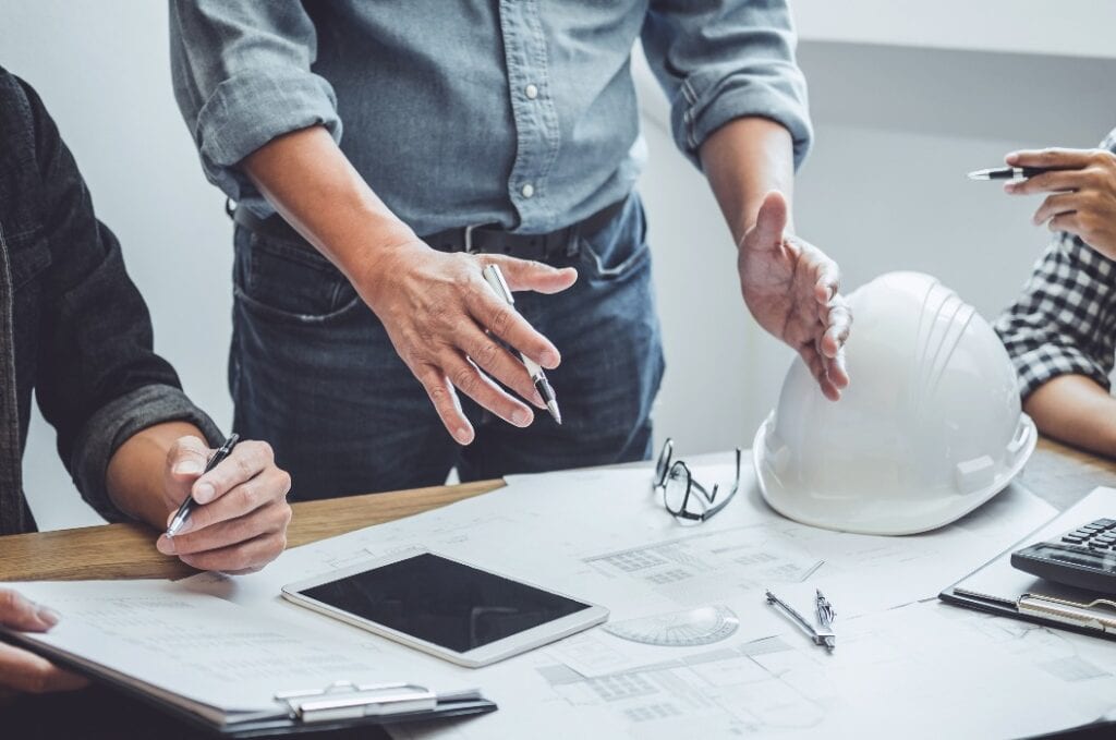 Construction and structure of Engineer or architect meeting for project working with partner and tools on model building and blueprint in working site